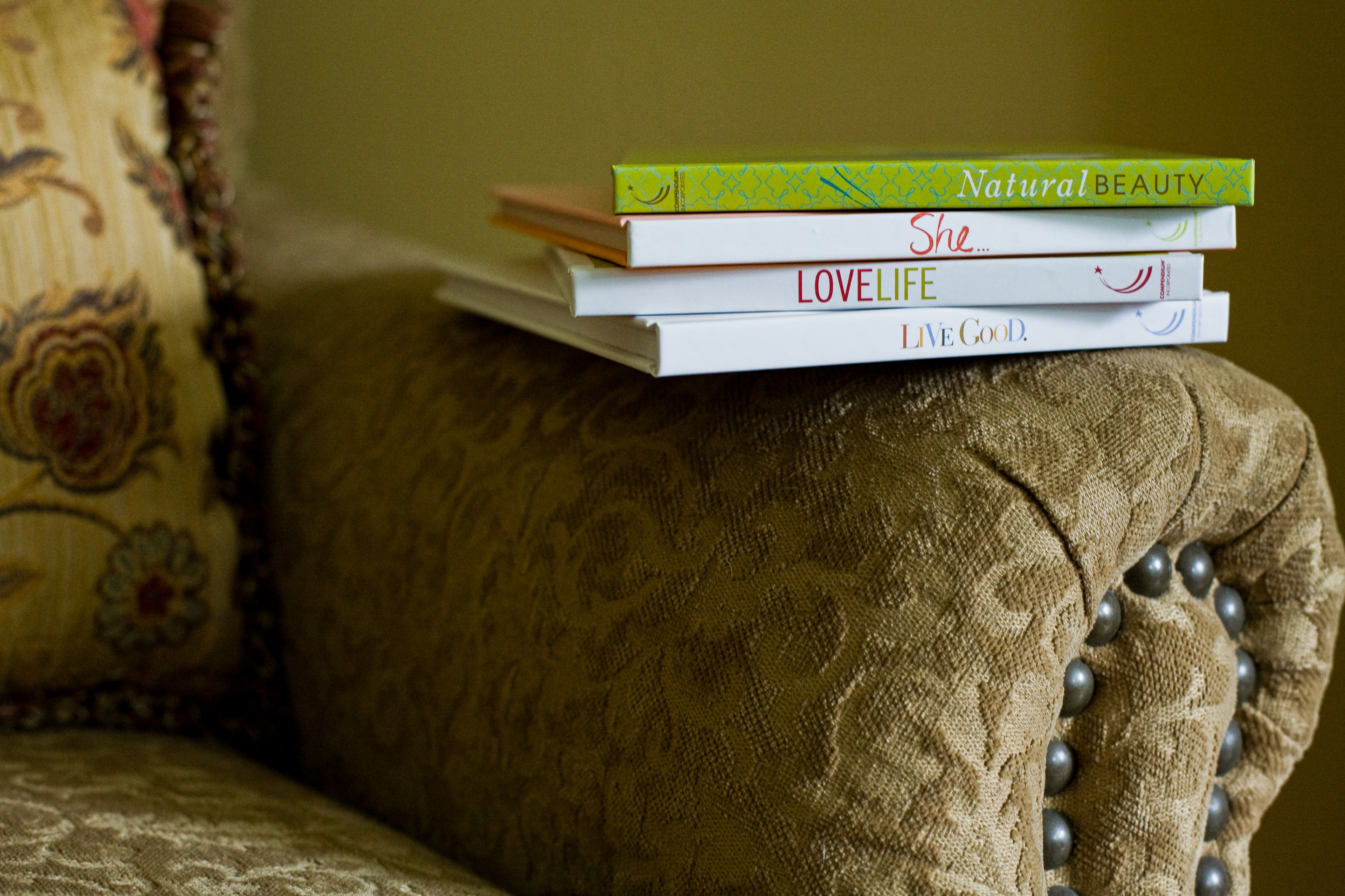 Stacked Books on Armchair — Products photography by Spice & Ink