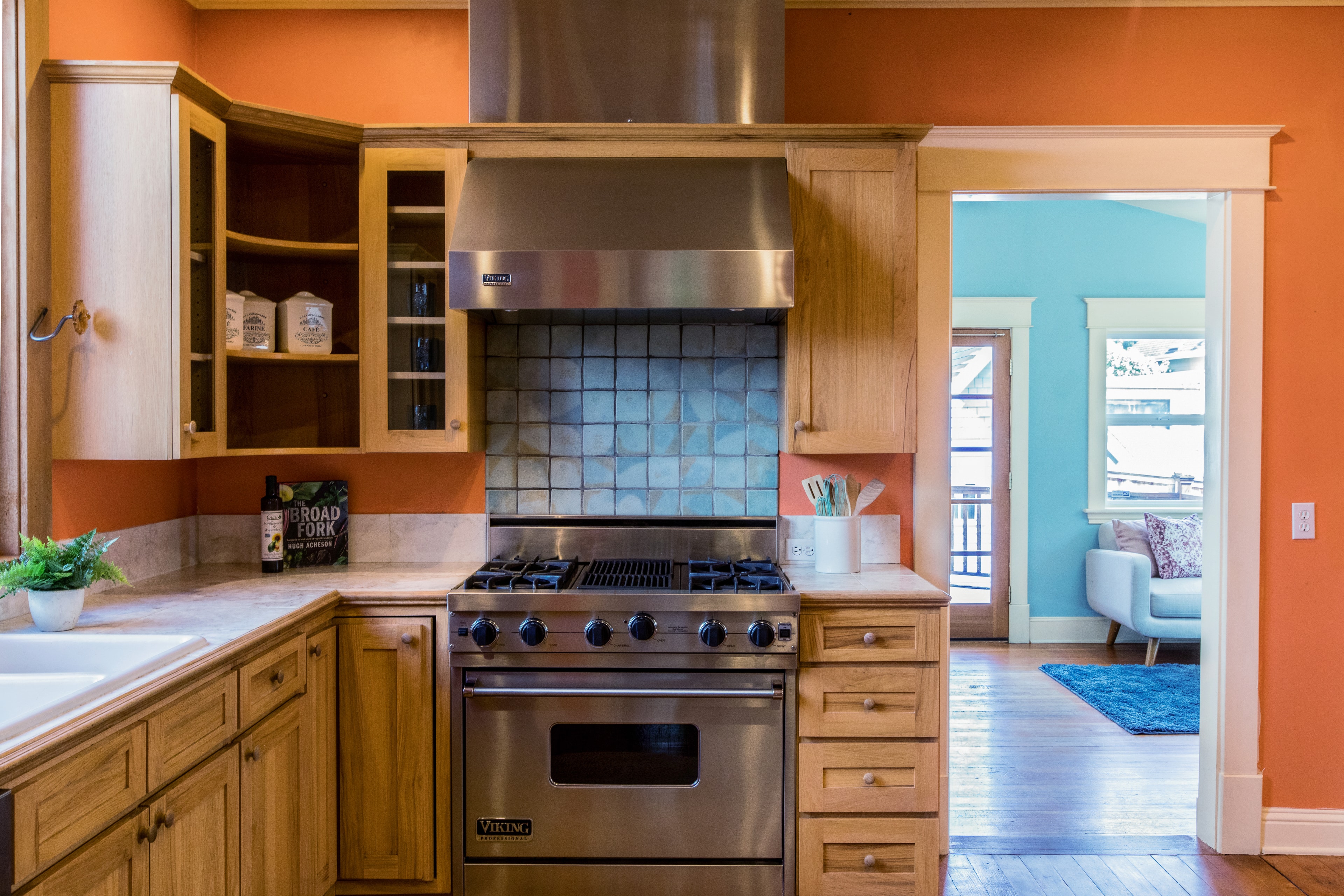 Modern Kitchen with Orange Walls — Spaces photography by Spice & Ink