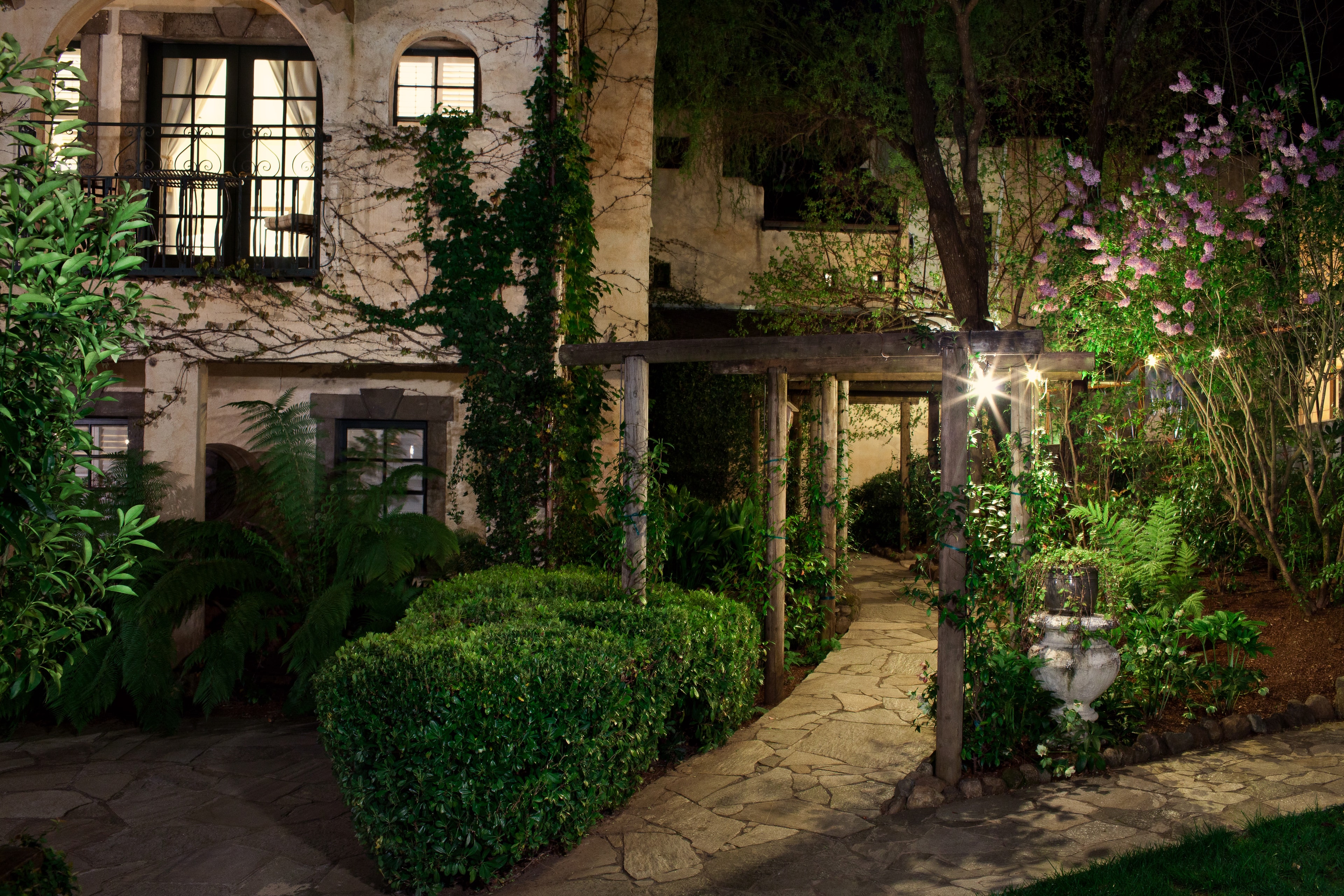Ivy-Covered Courtyard at Night — Spaces photography by Spice & Ink